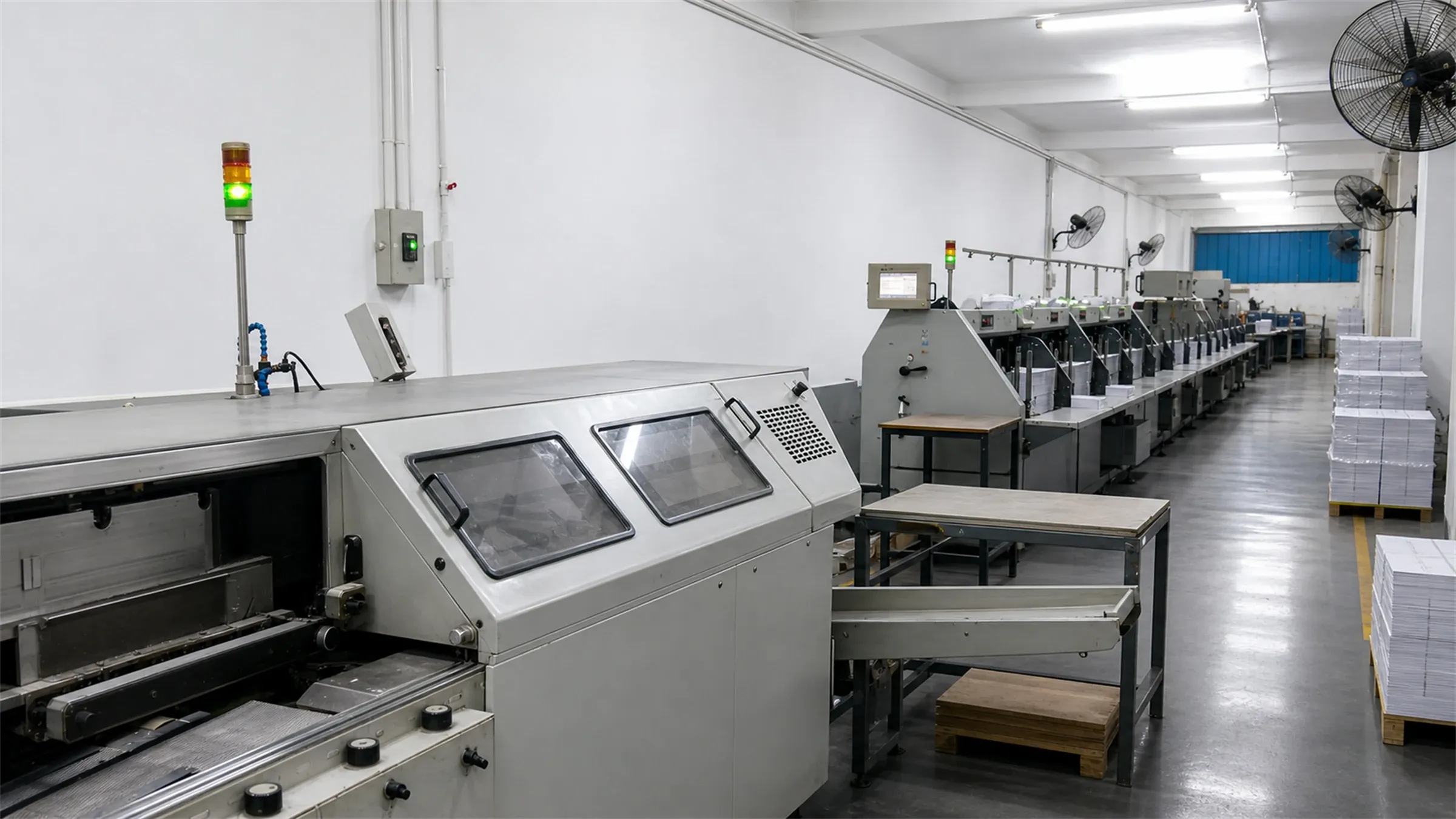 In-house bindery line with stitching and trimming stations